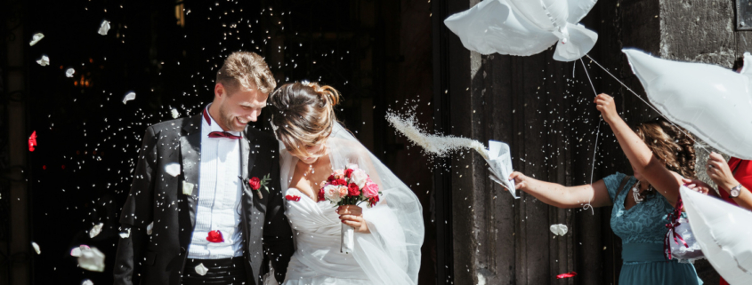 Bride and groom going out of church